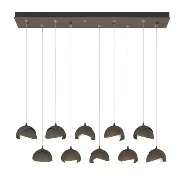The Brooklyn Collection features fixtures in many sizes and formats, including this large 10-Light Double Shaded linear version. With its rectangular pendant above, ten individual pendants can be aligned or staggered to suit the design at customizable heights on each cable. The Brooklyn Double Shade is available as a two-tone option, with shades that can be in contrasting finishes, if desired. Vermont artisans hand-forge and texture each shade. Available in any standard finish. - alternate view
