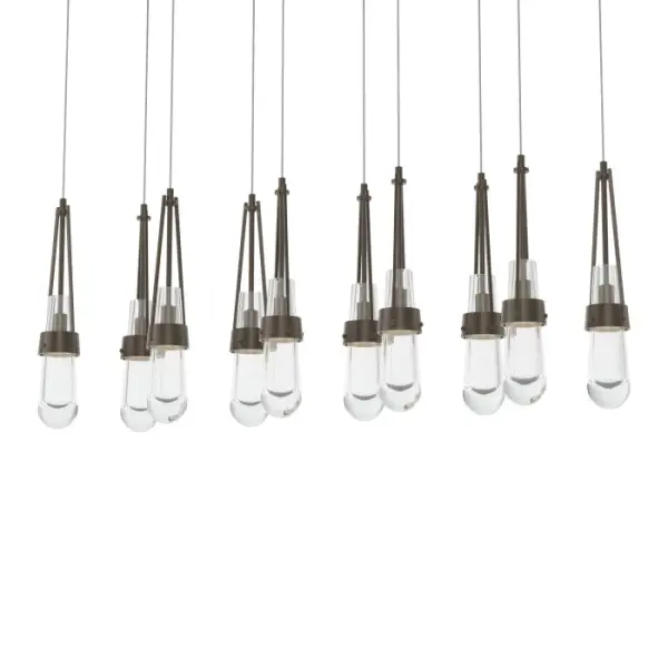This linear Link multi-port fixture provides key options for customization—2 rows of clear glass may be aligned or staggered at the desired lengths from its rectangular canopy. Steel cuffs, handmade by Vermont artisans, embrace the clear glass of this Link 10-Light ceiling fixture. Metalwork is available in all standard finishes. - alternate view