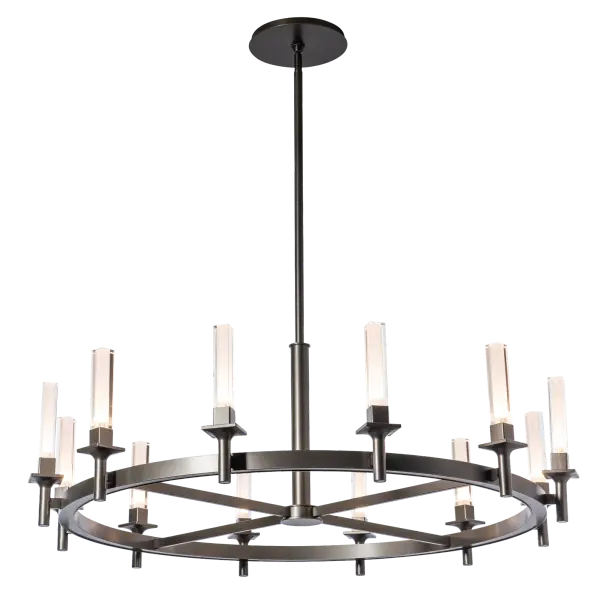 The Windsor 12-Light Chandelier is nearly 43" in diameter, the perfect size for many dining spaces. Each of the Windsor's squared base torches holds an exceptional piece of glass that is both tall and unique. It's rectangular outer glass contains a cylinder within that give a prismatic allure. Offered with a choice of a plated smoke mirror or crystal clear outer glass, each with a frosted inner cylinder that diffuses the light within. A choice of any of our standard interior finishes, or choose an optional RAL for a pop of unexpected color. - alternate view