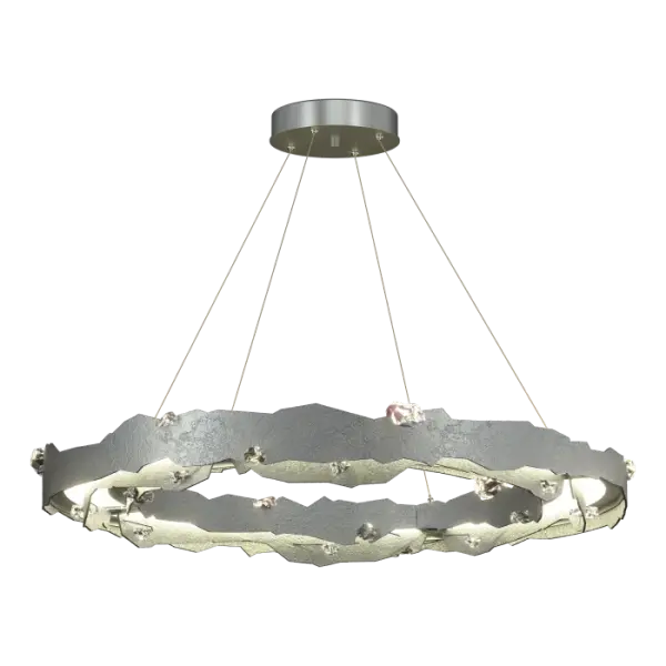 Design Team Leader Paul Marr Hilliard wanted to make a clear difference in the way crystals are used with the Trove LED Circular Pendant. “This is about geodes and the way the earth is broken open. This crystal shape is very raw and natural. Pairing that with our LED light-guide makes the crystals sparkle.” With a 38.2” diameter, the Trove makes a statement with its large crystals like buried gems in the rugged, hand-forged steel “mountains”.