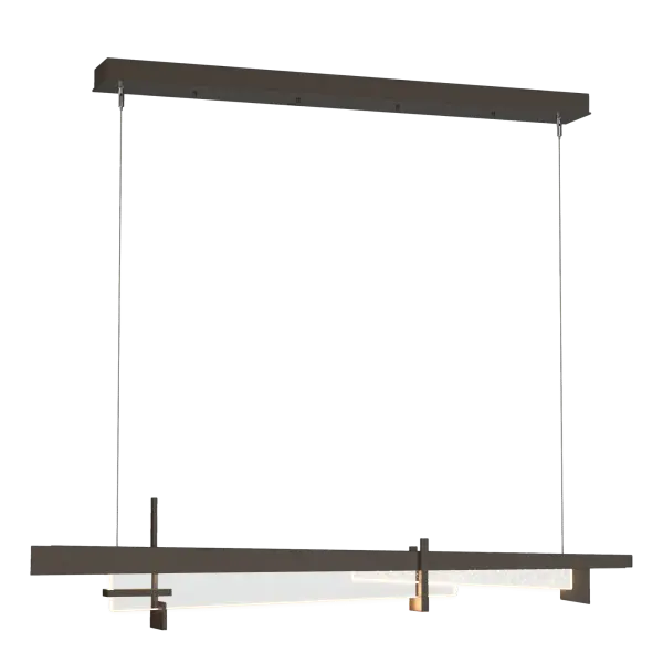 The Tenon Pendant brings together contemporary LED technology with a nod to the indelible design of the Arts and Crafts movement. Thick clear glass, clean steel lines and an element of seeded glass are hung from thin cables to form a streamlined and versatile pendant.