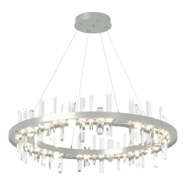 A floating ring of angular crystal towers provides the visual impact for this distinctive large scale pendant. Each crystal rises from an LED light guide and pierces through to emerge below, reflecting and refracting light in a vibrant sparkle.
