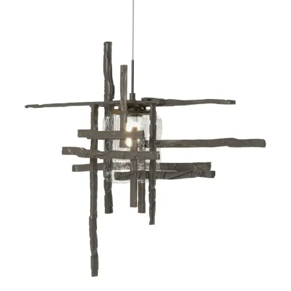 This Tura Mini Pendant is composed of perpendicular, intersecting handcrafted annealed aluminum pieces that form an exoskeleton that surround a thick, clear double layer of seeded glass. Suspended from a discrete round canopy, electricity is delivered via the pendant's low voltage cable. Available in all standard finishes. - alternate view