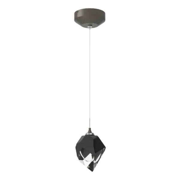 The Chrysalis 1-Light Large Crystal Pendant is a low-voltage fixture that features a single, handcrafted faceted small glass crystal suspended from a small round canopy. A thick, clear layer of glass is encased in an outer cocoon of hand-blown, colored glass (matte black or white). Hand-polished like a gemstone, the lower portion of the outer layer of glass is removed to reveal the inner crystal clear layer below and is lit from within.