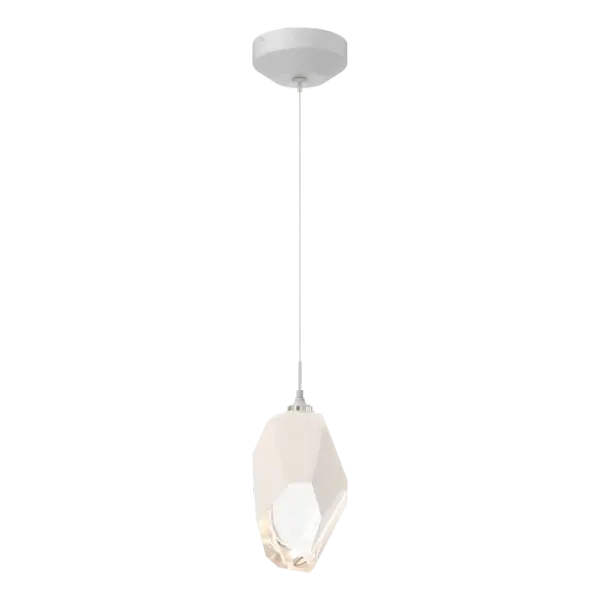The Chrysalis 1-Light Large Crystal Pendant is a low-voltage fixture that features a large, handcrafted faceted glass crystal suspended from a small round canopy. A thick, clear layer of glass is encased in an outer cocoon of hand-blown, colored glass (matte black or white). Hand-polished like a gemstone, the lower portion of the outer layer of glass is removed to reveal the inner crystal clear layer below and is lit from within.