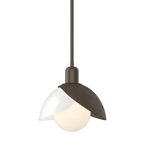 A larger single pendant, the Brooklyn Medium Double Shade Art Glass Mini Pendant features the Brooklyn's hallmark forged and textured steel shade that is uniquely paired with a contrasting white art glass shade to brilliant effect, with its exposed bulb that is nestled within the shades.