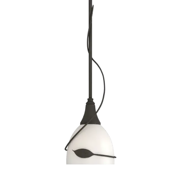 Our pendant is an example of "sylvan steel." A single tendril curls down the steel tube to wrap around the glass bowl, culminating in a finely-forged steel leaf. Handcrafted by artisans at our forge here in Vermont, each piece is unique.