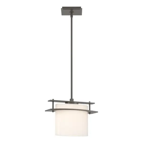 A horizontal steel bar connects tube to glass. The line of the steel plate racing across the glass makes it look as though metal has passed through glass of the pendant rather than the other way around. Crafted by our artisans here in Vermont.