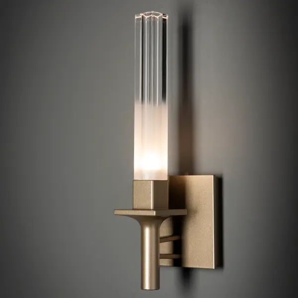 The Truss 1-Light Sconce brings a classic look that complements any architectural style. A single torch, squared at its base, offers up a tall rectangular gradiently frosted glass. An inner cylindrical shape gives a nearly prismatic effect to this unique glass. A simple, yet sophisticated wall sconce with the versatility to work with many styles. - alternate view