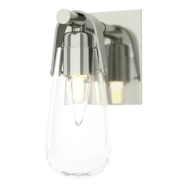Named for the Greek goddess of dawn, the Eos glass resembles an early morning dewdrop. The Eos 1-Light Bath Sconce features a clear glass vessel held by a U-shaped metal band and backplate.