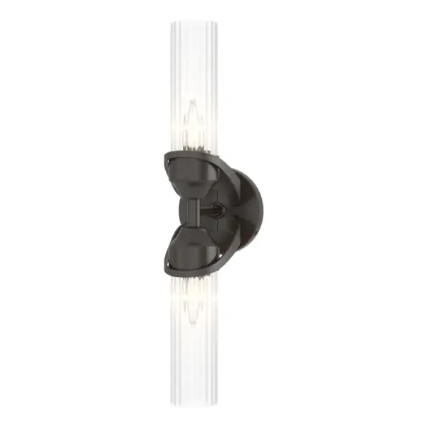 The Bow 2-Light Bath Sconce can be placed vertically or horizontally in any spa bath environment. A traditional shape, the Bow's ribbed glass cylinder shades give it an Art Deco feel. Forged metal collars, handcrafted by Vermont makers, are affixed to its round backplate.