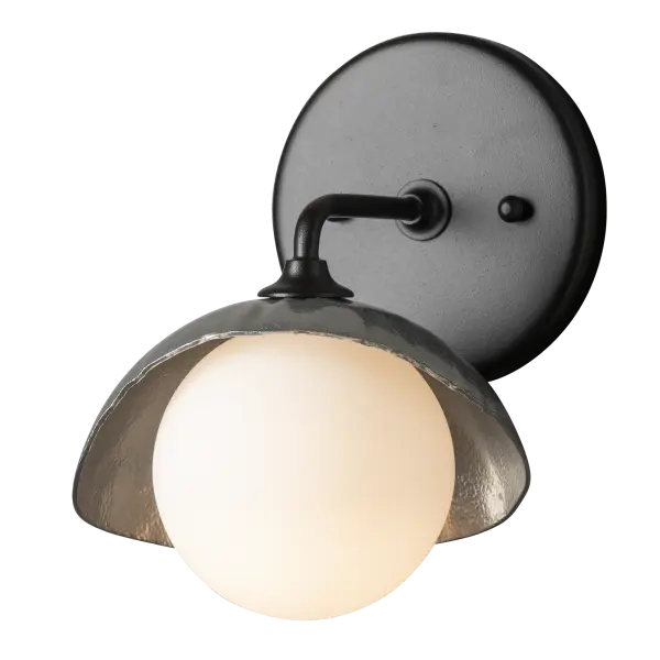 This single shaded Brooklyn wall sconce is the perfect addition to add light to a smaller space on either side of a mirror in a bath environment. The Brooklyn 1-Light Single Shade Bath Sconce's metal shade is forged by Vermont artisans. Two-tone finish options available.