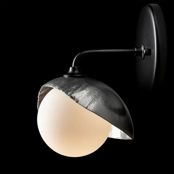This single shaded Brooklyn wall sconce is the perfect addition to add light to a smaller space on either side of a mirror in a bath environment. The Brooklyn 1-Light Single Shade Bath Sconce's metal shade is forged by Vermont artisans. Two-tone finish options available. - alternate view