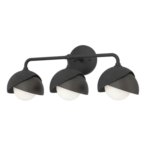 With an overarching curved arm, this Brooklyn wall mount features three 2-shaded glass globes. Shades are available in a two-tone option with a choice of accent color for a contrasting finish, if desired. Forged in 1800º fire, the shades are handcrafted and textured by Vermont makers.