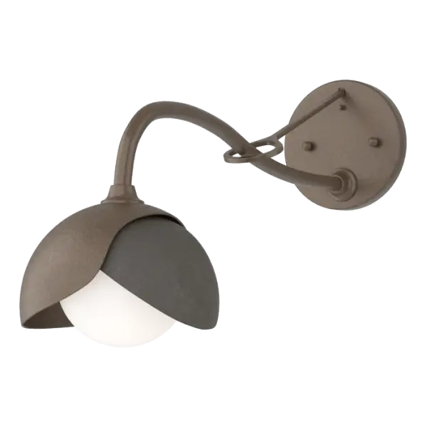 With a gracefully curved, extended arm with greater reach for those situations where needed, the Brooklyn 1-Light Double Shade Long-Arm Sconce is the perfect solution. Shades may be crafted in a two-tone option with contrasting finishes, if desired. The handcrafted nature of the metal is evident by the texturing from the heat of the fires of the forge. Handmade by Vermont artisans. Available in Black, Oil Rubbed Bronze, Vintage Platinum, Soft Gold, Sterling and Modern Brass.