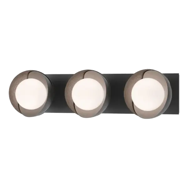 A linear wall mount that can be positioned either horizontally or vertically, this Brooklyn 3-Light Double Shade is ideal above or on either side of a mirror in a powder room or bath. The shades are hand-forged and shaped by Vermont makers and can be adjusted for position. A two-tone option is offered for shade finishes, should contrasting colors be desired.