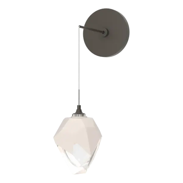 The Chrysalis Small Low Voltage Sconce features a small, handcrafted faceted glass crystal. You can custom-set the drop height, creating unique opportunities for vanity, beside and other applications. The Chrysalis’ trademark thick, clear layer of glass is encased in an outer layer of hand-blown, colored glass (matte black or white). Hand-polished like a gemstone, the lower portion of the outer layer of glass is removed to reveal the inner crystal clear layer below that is lit from within.
