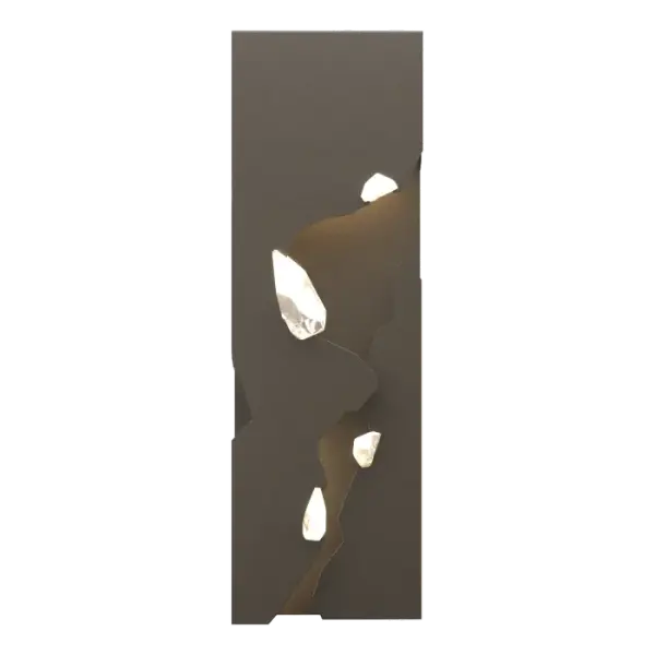 Both visually rich and dramatic, the Trove sconce interchanges points of jeweled light and planes of textured steel. Inspired by crystal in raw form, the featured crystal resembles treasure buried in its steel mountain.