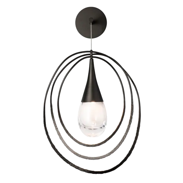 This elegant drop-sconce promotes personalization, with its ability to display with a short cable, long, or anywhere in-between. The Lyric gives off ample reading light at bedside, great functional light beside a mirror in a stylish bathroom, or wherever it is placed. The Lyric's thick rounded bottom glass teardrop is capped by a sleekly shaped metal form. Available in any of our standard interior finishes. - alternate view