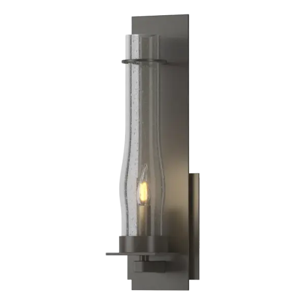 There's a sense of strength and permanence when you look at a classic example of hand-worked iron. The clear, seeded hurricane glass gives this vertical sconce a sense of old-world charm.