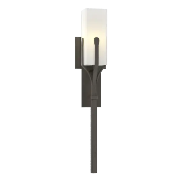 Our Mediki Sconce could be considered a modern (and durable) update to the tiki torch. The artisans at our Vermont forge use hand-shaped steel to form a cradle around the square glass tube.