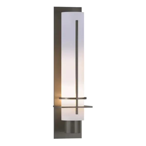 Ideal for a creating a soft mood, our After Hours Sconce has a long narrow glass tube to shield and diffuse the light. Sculpted metal bands provide visual interest. Crafted here at our Vermont forge, each piece is unique. - alternate view