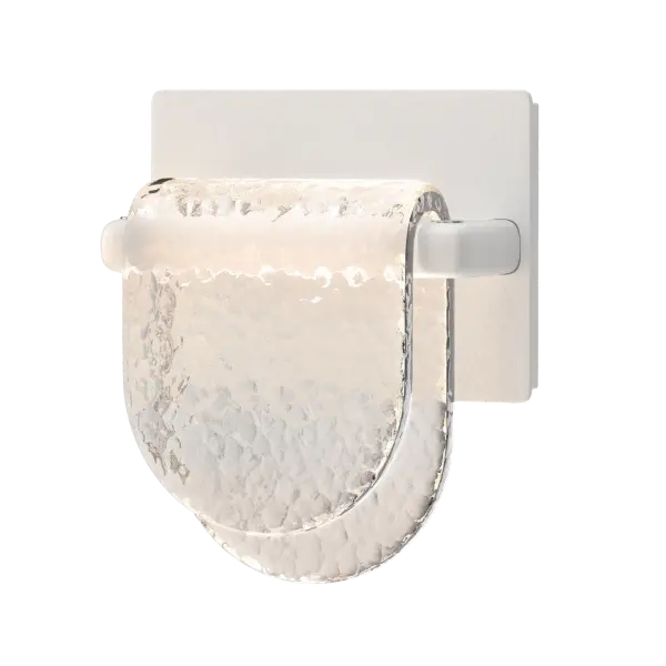 Small and stunning. This glass is beautifully hand-crafted by our friends at AO Glassworks in Vermont. Clear, heavily textured glass is hand-poured and shaped to create this unique wall sconce. The thick glass bends over a small metal bar, giving it the delicate whimsy of a meandering riverbed.