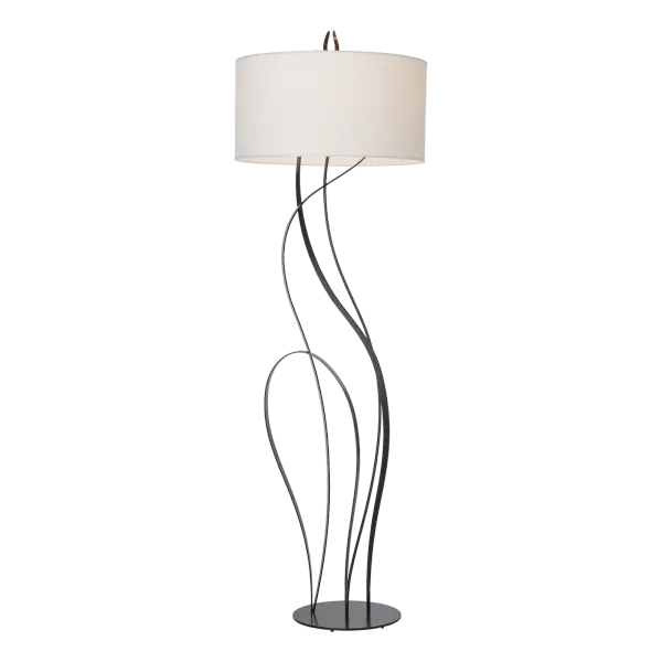 Beautiful flowing ribbons of steel are hand-shaped in the fires of the forge to resemble the swaying high grasses of summer in the stunning Sway Floor Lamp. A sense of movement and sensuality is embodied in the Sway. The lamp’s round base and large round fabric shade complement the design.