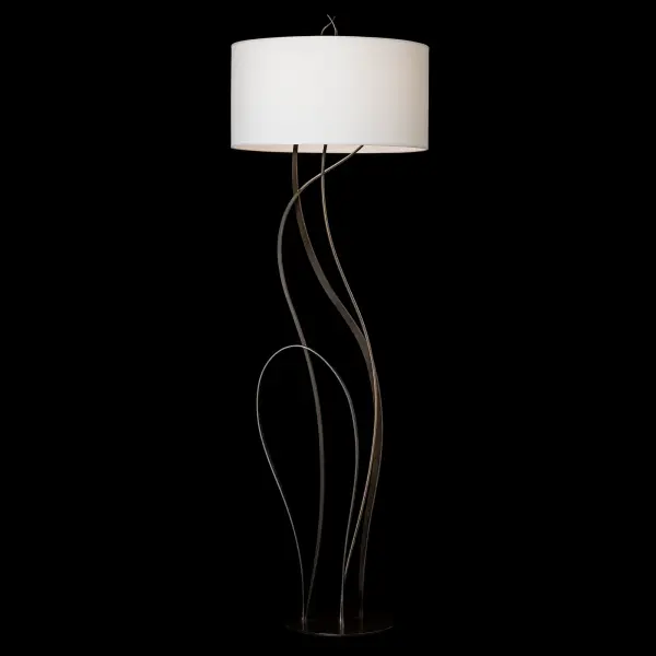 Beautiful flowing ribbons of steel are hand-shaped in the fires of the forge to resemble the swaying high grasses of summer in the stunning Sway Floor Lamp. A sense of movement and sensuality is embodied in the Sway. The lamp’s round base and large round fabric shade complement the design. - alternate view