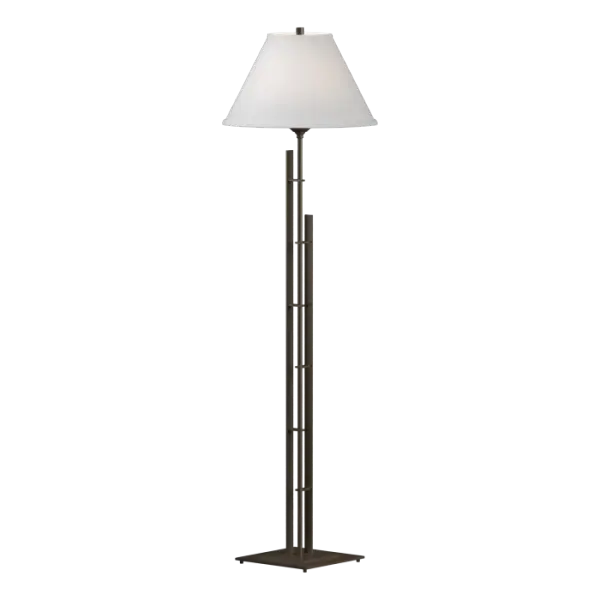 The stylish shade topping the steel tube of our Metra Floor Lamp looks like it's striving to reach the sky. Steel bars accompany and support the tube on its vertical journey. The fine, straight lines of the design readily add a touch of class to a room.