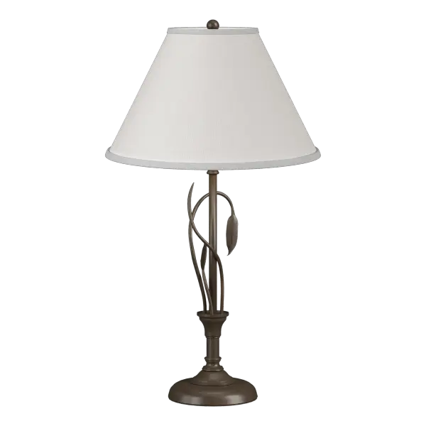 Our table lamp is an example of "sylvan steel." Stems of hand-forged iron sprout from the lamp post, with one gently curved stem culminating in a finely-crafted leaf. Shaped by artisans at our forge here in Vermont, each piece is unique.