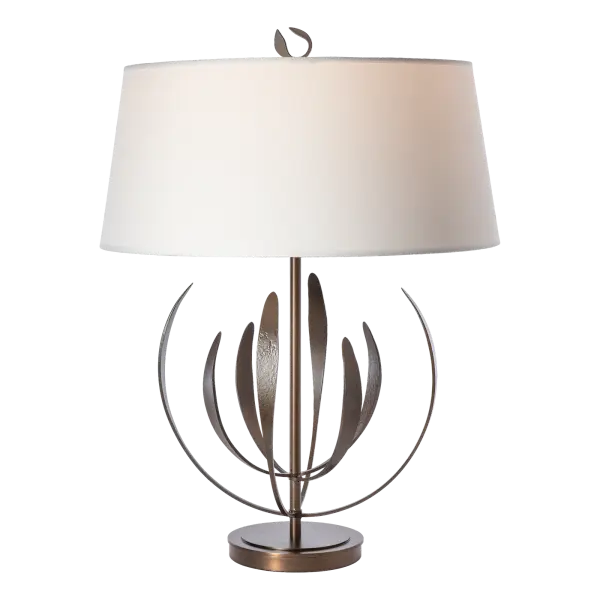 From our iconic Dahlia pendant comes this stunning table lamp designed by Paul Marr Hilliard. With two tiers of four upward reaching, delicate "petals" each, the Dahlia Table Lamp exudes grace and elegance. Petals are handcrafted by Vermont artisans in the 1800º red-hot fires of the forge. The finial detail is pure perfection, peeking out from above its beautiful fabric shade. - alternate view