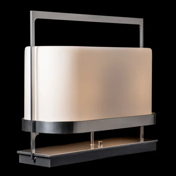 Serenity Table Lamp, a harmonious blend of elegance and nature-inspired design. Crafted with a steel protective frame that gently cradles a soft glass shade, this lamp evokes the serenity of Vermont's picturesque farm fields in early summer with their white wrapped bales of hay.