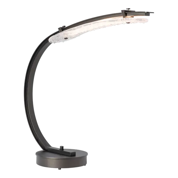 Inspiration for the Glissade struck designer Andy Morter as he was walking across an icy midwestern pond. “ were unlike anything else I’d seen in nature. There’s something raw and beautiful in that contrast—sharp yet serene, delicate yet strong.” With its gracefully curved steel arm and base dimmer, this table lamp does double work as both a decorative and task light.