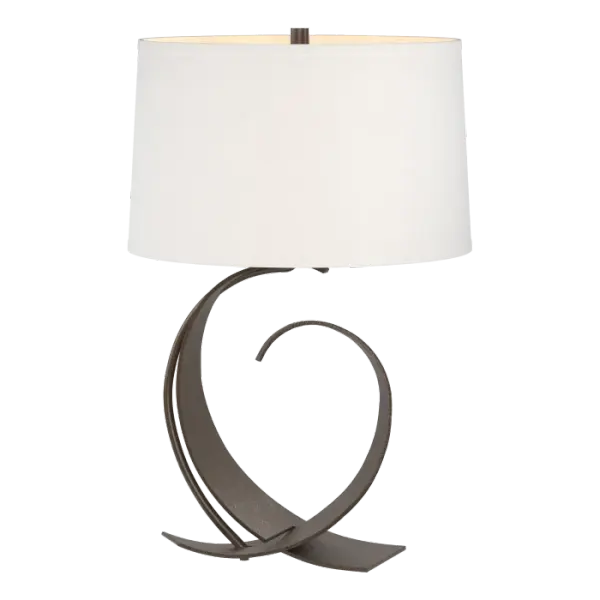 When this table lamp was introduced, it included impressions in the steel created by a fuller hammer. Today, the heavy steel of our Fullered table lamp still comes in full curves, but not fullered curves. Forged by artisans here in Vermont, each piece is unique.