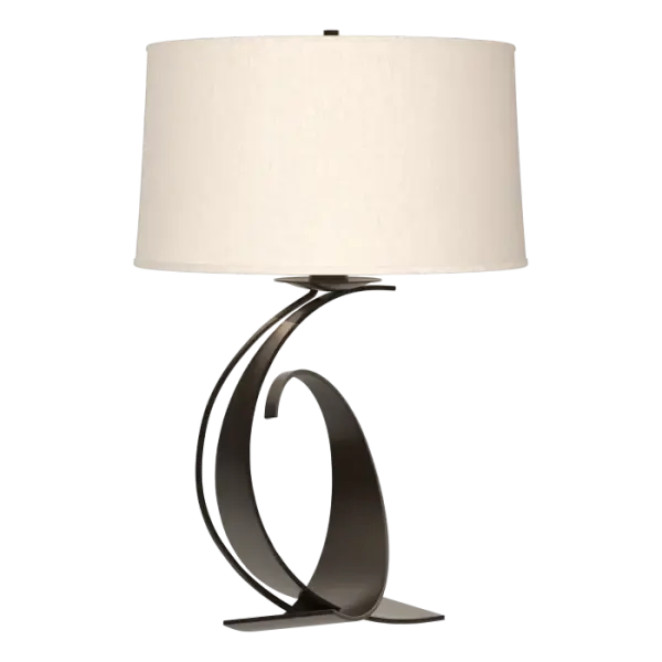 When this table lamp was introduced, it included impressions in the steel created by a fuller hammer. Today, the heavy steel of our Fullered table lamp still comes in full curves, but not fullered curves. Forged by artisans here in Vermont, each piece is unique.