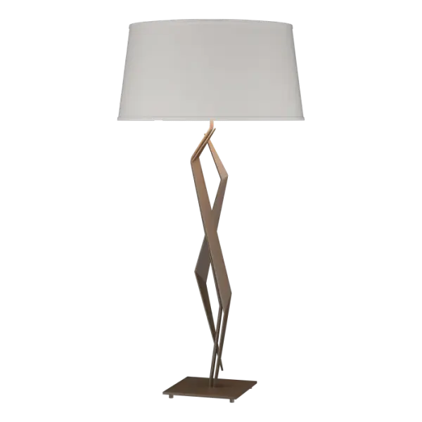 Suggestive of a fine cut gem, our Facet Collection offers a truly unique design. Our table lamp displays an interplay steel angles and planes sure to be the crowning jewel of a well-designed space. Shaped by artisans at our forge here in Vermont.