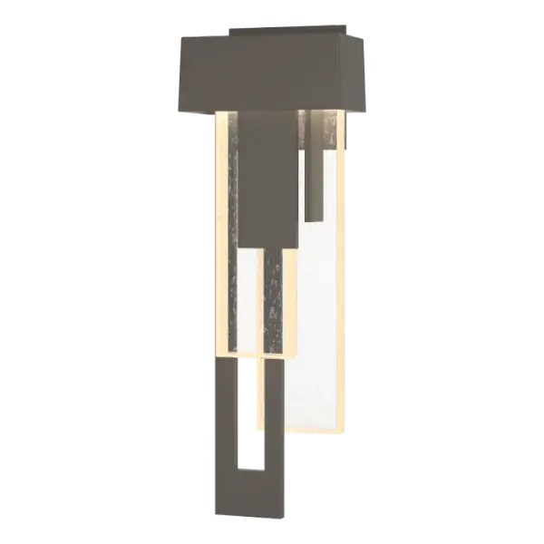 Cascades of thick seeded glass and layers of metal create a bold and sophisticated display of elements. The medium Rainfall sconce combines traditional architectural forms with streams of textural light play.
