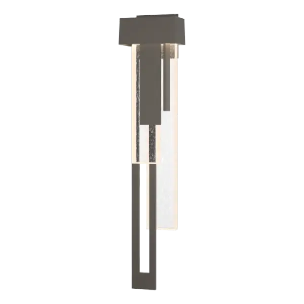Cascades of thick seeded glass and layers of metal create a bold and sophisticated display of elements. The large Rainfall sconce combines traditional architectural forms with streams of textural light play.