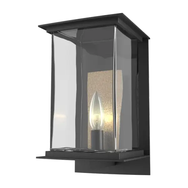 The Kingston Outdoor Medium Sconce is a 1-light wall sconce, perfect to light the front of a home, or for lighting an outdoor kitchen or back patio entrances. The Kingston Collection blends crisp architectural elements and candelabra lighting with a large rectangular blown glass that forms a versatile look on numerous home styles.This difficult to produce glass highlights the organic nature that clear glass can have with its subtle variations of thickness and patterns. The accent reflector plate behind each candelabra adds both a traditional element and a splash of contrast as it is available in our Vintage Platinum and Soft Gold finishes. Also offered as a 2-light larger version.