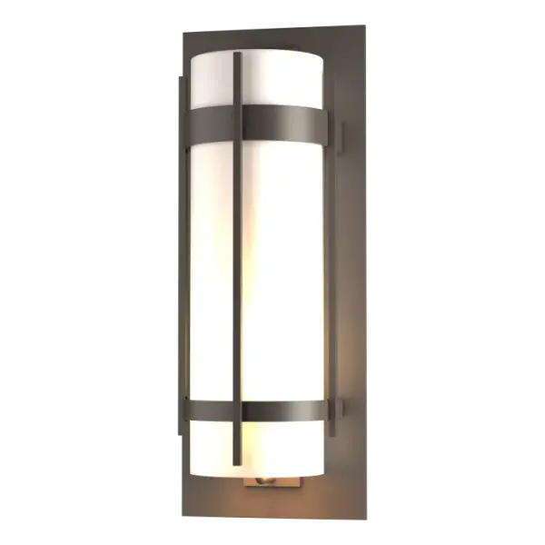 A clean, sleek design that evokes dreams of the Far East is the hallmark of our Banded Collection. True to name, our Grande-Sized Outdoor Sconce has two handcrafted metal bands, intersected by a vertical bar, circling the glass and fastening to the mounting plate.