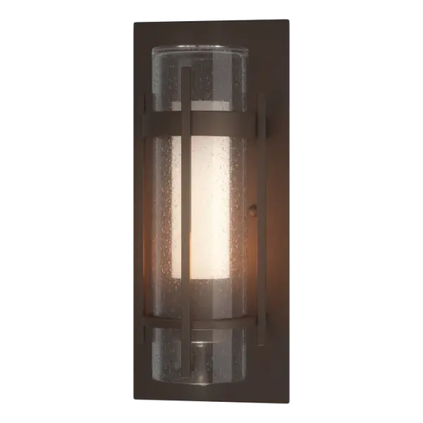 Our Torch Collection, with its two hallmark circular metal bands and perpendicular metal accent, is available in 2 different sizes. Offered with a stunning seeded outer glass cylinder combined with a frosted inner glass, this Torch Outdoor Sconce is available in all of our robust Coastal Outdoor Finishes. The Torch Outdoor Sconce is also available in a large version.