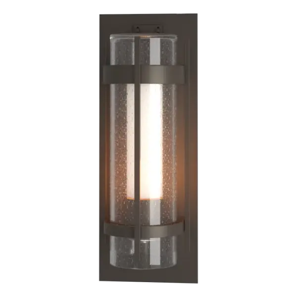 This Torch Large Outdoor Sconce, with its two hallmark circular metal bands and perpendicular metal accent, is available in all our robust Coastal Outdoor Finishes. The Torch Sconces are offered with a substantial and stunning seeded outer glass cylinder combined with a frosted inner glass for stylish, yet functional lighting. The Torch Outdoor Sconce is also available in a medium version.