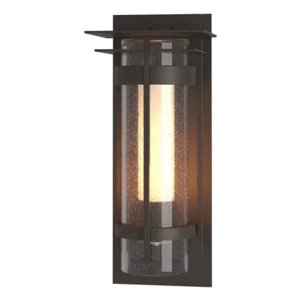 The ever-popular Torch Outdoor Collection puts a contemporary spin on a timeless design. In addition to the two hallmark circular metal bands and its perpendicular metal accent, this Top Plate version offers a square metal accent and top plate. Available in all our robust Coastal Outdoor Finishes. The Torch Outdoor Sconce with Top Plate is also available in a medium version.