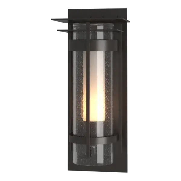 Making a big impression, the Torch XL Outdoor Sconce with Top Plate measures 25.9" in height, and is a great addition to the ever-popular Torch Outdoor Collection. With a more contemporary look, the Torch XL features an opal inner with clear seeded outer glass cylinder. Available in any of our robust Coastal Outdoor Finishes, the Torch XL Outdoor Sconce with Top Plate precludes uplight and focuses the light where it's needed, and creating a warm welcome for guests.