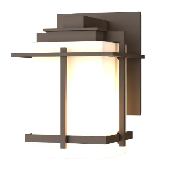 Although the design is in honor of traditional Japanese stone lanterns, our Tourou Outdoor Sconce is much easier to mount on the outside of your home or business. Metals bands crisscross and hug the square glass tube for design flare.