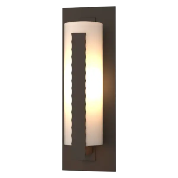 The vertical steel bar shielding the glass tube makes it clear where the name for our Vertical Bar Outdoor Sconce comes from. What's also clear, on closer look, is the craftsmanship and quality that goes into this seemingly simple wall sconce.