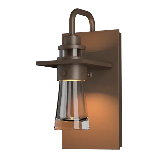 Inspired by the flat-bottomed Erlenmeyer flask, our outdoor sconce provides the catalyst for your design chemistry. The thick, clear blown-glass flask is encircled by a metal collar which is in turn, embedded in a metal plate.