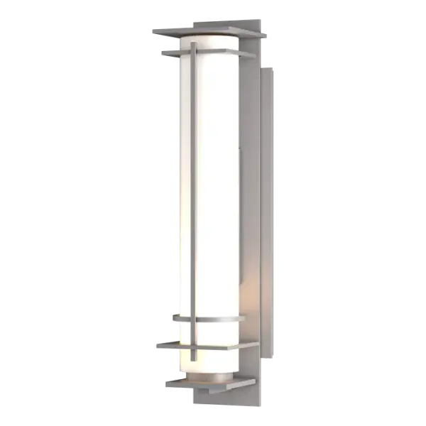 Ideal for a creating a soft mood, our After Hours Outdoor Sconce uses a long narrow glass tube to shield and diffuse the light source. Sculpted metal bands provide support and visual interest. Crafted at our forge here in Vermont, each piece is unique.