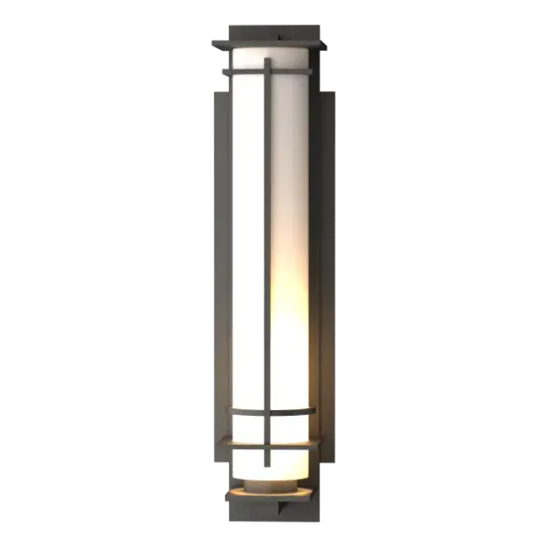 Ideal for a creating a soft mood, our large After Hours Outdoor Sconce uses a long narrow glass tube to shield and diffuse the light source. Sculpted metal bands provide support and visual interest. Crafted at our forge here in Vermont, each piece is unique.